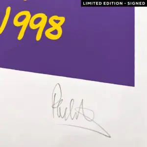 A close-up of the Poster Phil Collins, 1998, Limited Edition shows “1998” in yellow on a purple background. A pencil signature appears at the bottom right, and the top right black label reads "LIMITED EDITION - SIGNED.