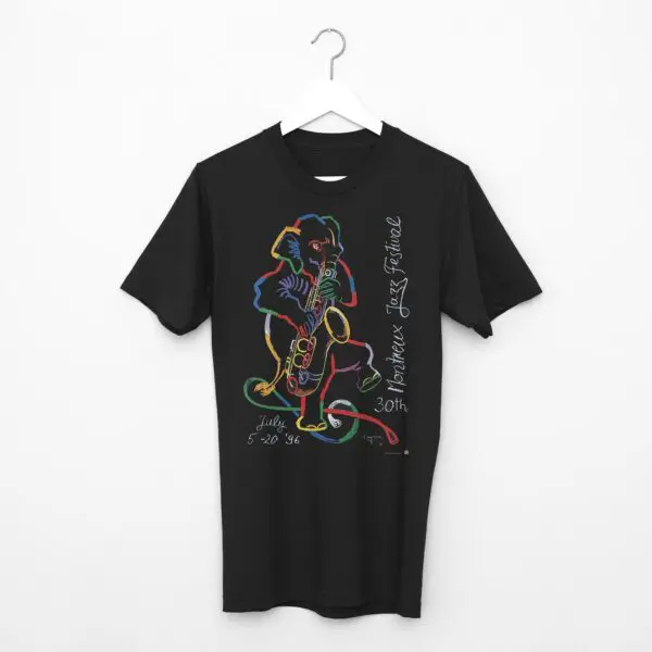 T-Shirt Rolf Knie, 1996: Black tee on hanger with Rolf Knie's colorful abstract mouse playing saxophone and handwritten "30th Montreux Jazz Festival, July 5-20 96" text.
