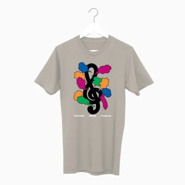 The T-Shirt Shigeo Fukuda, 1985 hangs on a hanger in light gray, featuring a bold black treble clef with colorful cloud-like shapes and stars. Small white text sits under the Montreux-inspired design.