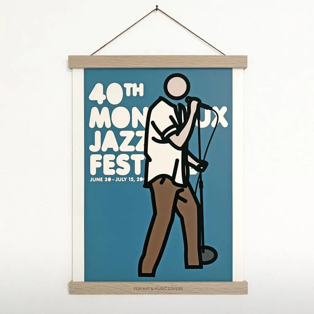 The Magnetic Engraved Poster Holder displays a minimalist design of a singer with a microphone, promoting the 40th Montreux Festival (June 30–July 15). A black-outlined figure stands on a blue background with solid colors, no facial features.