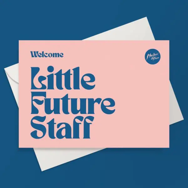 A pink Little Future Staff Card with bold blue text reading "Welcome Little Future Staff Music" is displayed on a white envelope, set against a solid blue background. A small circle in the top right reads "MotherCare Offices.