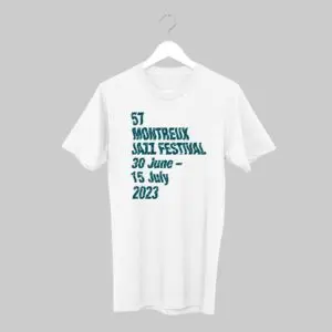 The T-Shirt Guillaume "SupaKitch" Grando, 2023, hangs against a gray background with teal text on the front: 57 Montreux Jazz Festival, 30 June – 15 July 2023.