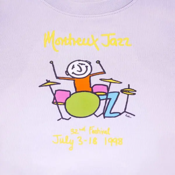 Dessin illustré pour le Montreux Jazz Festival représentant un personnage jouant d'une batterie colorée, avec le texte de l'événement : "32e Festival 3-18 juillet 1998" en écriture jaune sur fond clair.
