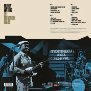 Black-and-white photo of Muddy Waters playing guitar on stage at Montreux Jazz Festival with band and signage. Album tracks and credits featured on this classic release, "Muddy Waters, The Montreux Years, Double Vinyl.
