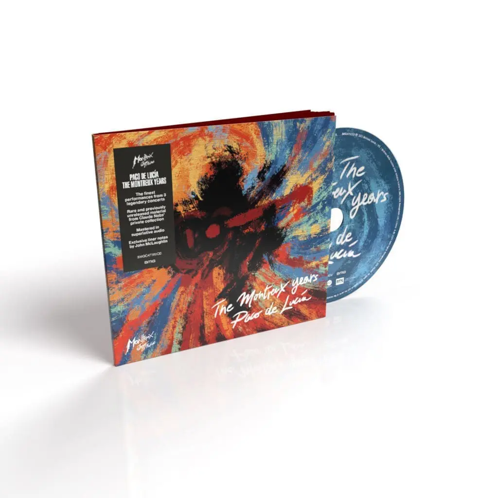 A CD titled Paco de Lucia, The Montreux Years is displayed, its abstract cover featuring swirling reds, blues, and yellows. The blue CD is partially visible as it peeks out from the upright open case.