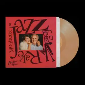 Un disque vinyle de couleur havane sort d'une pochette rouge ornée d'un lettrage gras et d'une image de RAYE, célébrant la sortie de "RAYE, Live at Montreux Jazz Festival, Vinyle".