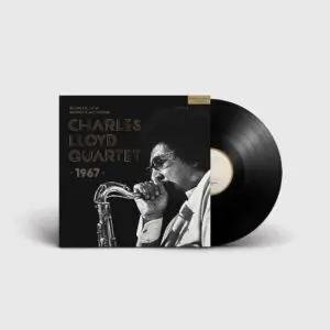 A vinyl record partially out of its sleeve. The cover reads Charles Lloyd Quartet, Live at Montreux Jazz Festival, 1967, and features a black and white photo of a man playing saxophone on a plain white background.