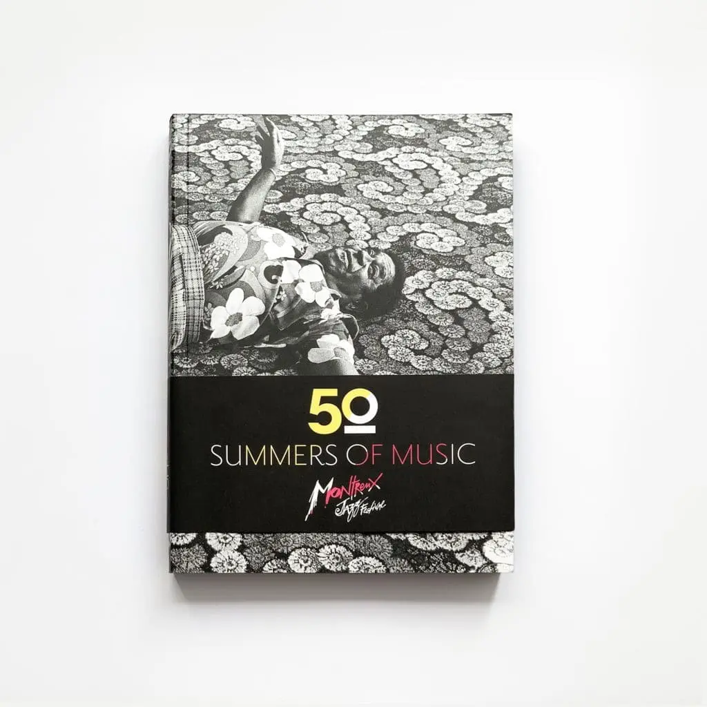 50 Summers Of Music is a book featuring a black-and-white cover photo of someone in a floral shirt on a patterned surface, with the Montreux Jazz Festival logo below the title.