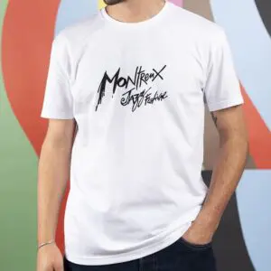A person wearing a white T-Shirt Montreux Jazz Festival with stylized black festival text stands against a colorful, abstract background. Only the torso and part of the face are visible.