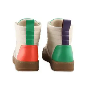 A pair of Lakeside Wooler Sneakers by Baabuk, Limited Edition—high-tops with beige uppers, brown soles, green back stripes, mismatched red and green heel accents, and a purple pull tab, inspired by the Montreux Festival style.