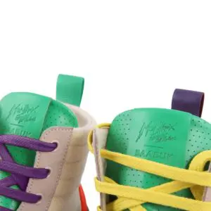 Close-up of two sneaker tongues: the left with green wool and purple laces, the right with yellow laces—both embossed with Montreux and BAABUK, honoring the Limited Edition Lakeside Wooler Sneaker and the Montreux Festival.